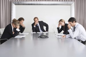 Frustrated Businesspeople Listening to Conference Call